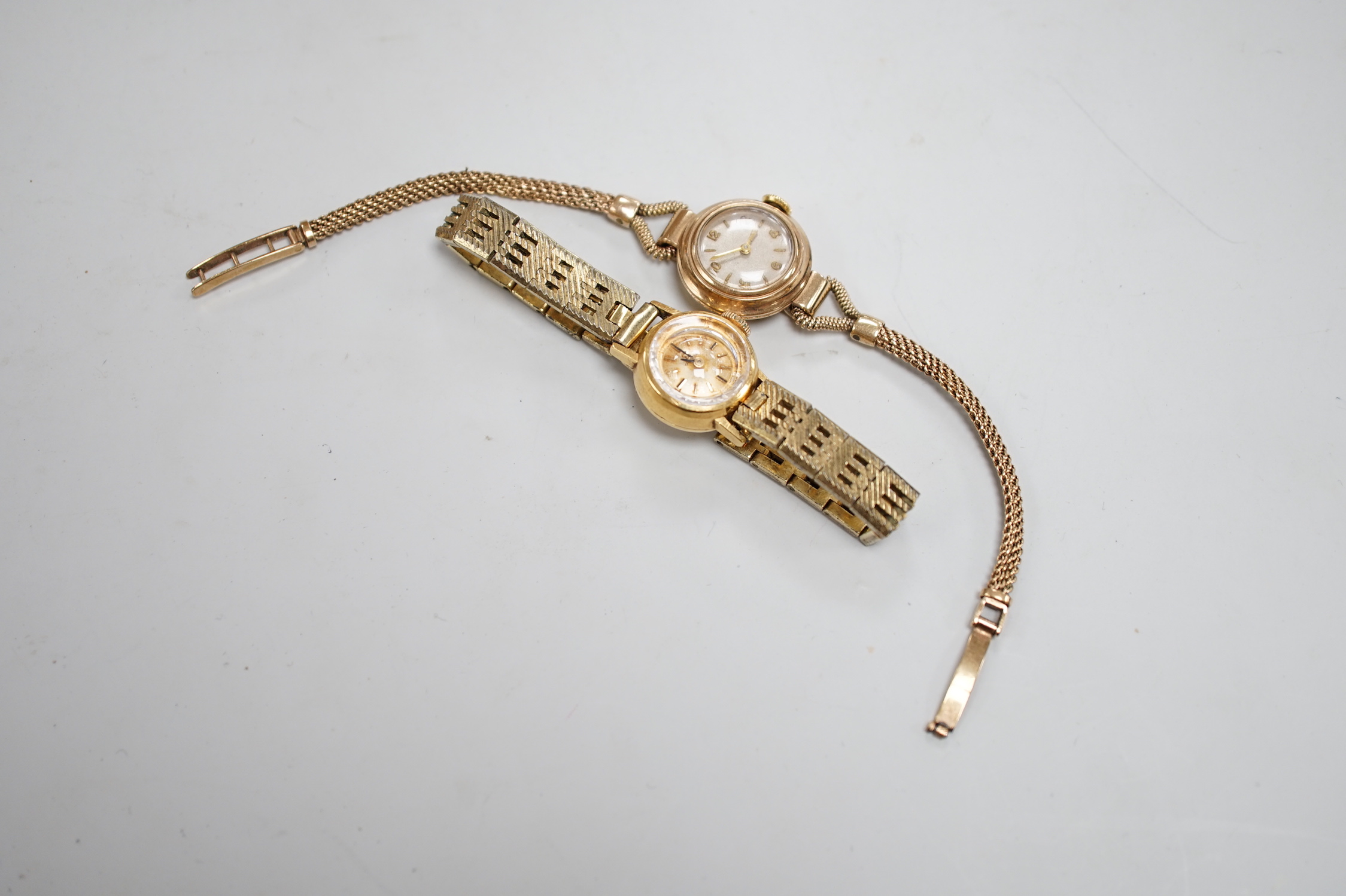 A lady's 9ct gold Omega manual wind wrist watch, on a gold plated bracelet, together with a lady's 9ct gold manual wind wrist watch, on a 9ct gold bracelet.